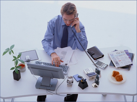 man-at-desk-computer-tele